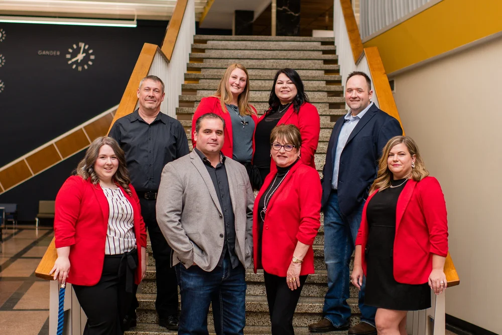 Turner Realty Team on the historic Gander International Airport staircase — Royal LePage real estate agents in Central Newfoundland